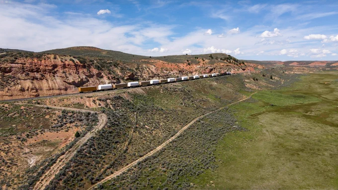 Union Pacific’s new commemorative locomotive is seen traveling by rail through the mountains of Utah as it hauls the final eight booster motor segments for the NASA Artemis III mission to NASA Kennedy. Image Credit: NASA/Brandon Hancock