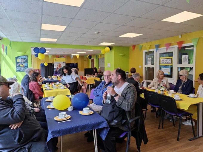Sutton Vision celebration at Volunteer Week.  Volunteers seen sitting at table