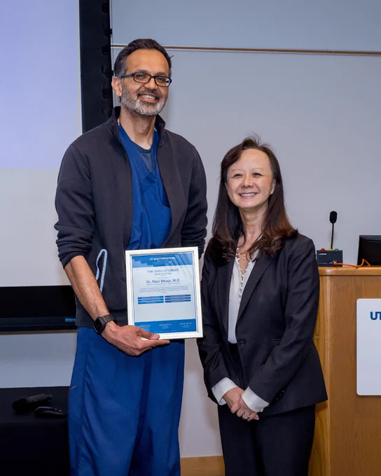 Dr. Ravi Bhoja holding his award