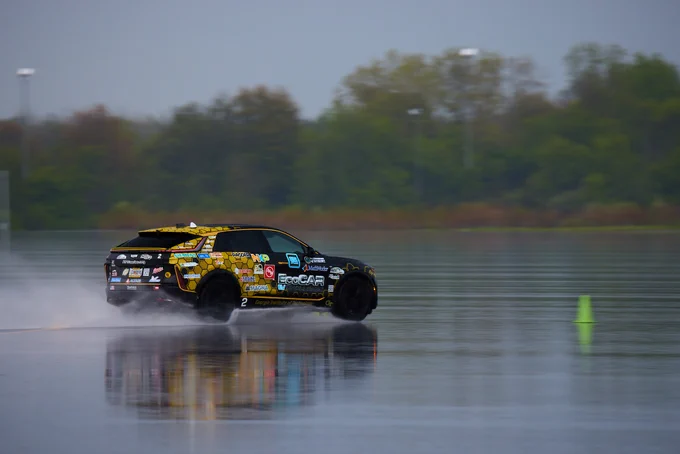 Georgia Tech's reengineered Cadillac LYRIQ EV drives across wet pavement during testing.