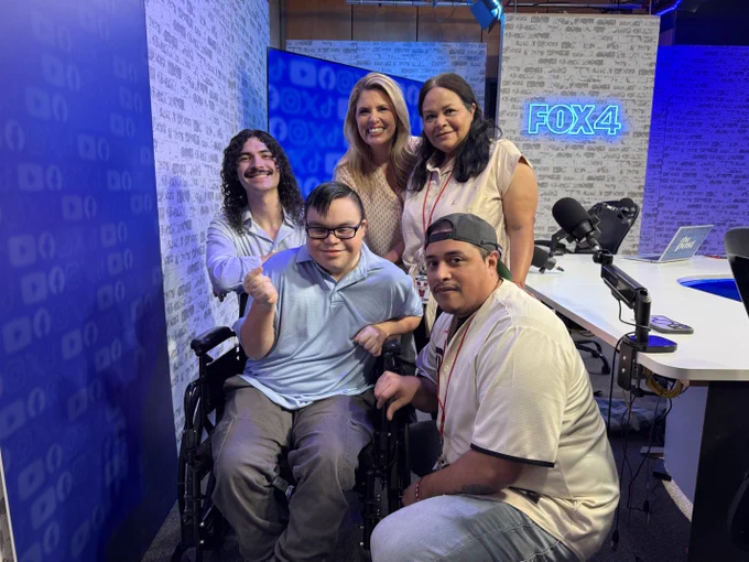 photo of 4 adults and one student inside a news room