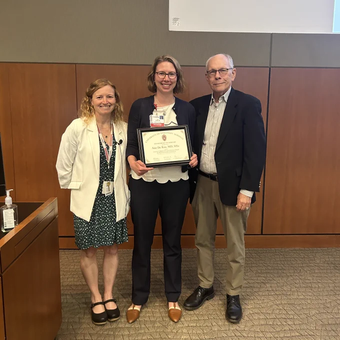 Drs. Courtney Morgan, Ana De Roo and Layton Rikkers stand together for a picture. Dr. De Roo is holding her award.
