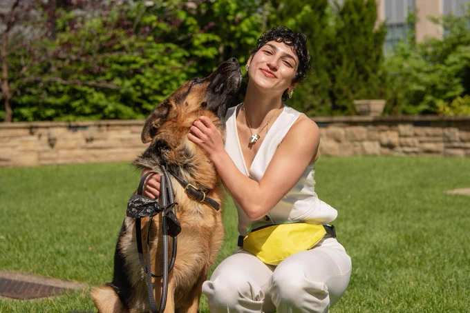 Rosie Franjoine and Polo, a young German Shepard embrace while on campus.