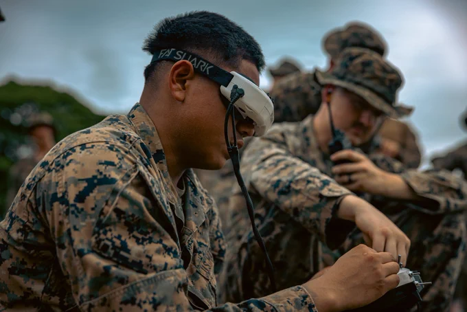 U.S. Marine Corps Lance Cpl. Juan Peragine, left, an attack drone operator with 3rd Light Armored Reconnaissance Battalion, currently forward deployed with 4th Marine Regiment, 3rd Marine Division as part of the Unit Deployment Program, operates the Neros Archer during a live-fire range on Camp Schwab, Okinawa, Japan, May 28, 2026. The range was conducted to familiarize Marines from 2nd Battalion, 8th Marine Regiment, 3rd Battalion, 7th Marine Regiment, and 3rd Light Armored Reconnaissance Battalion on the Neros Archer drone. Peragine is a native of Florida. (U.S. Marine Corps photo by Cpl. Joaquin Dela Torre)