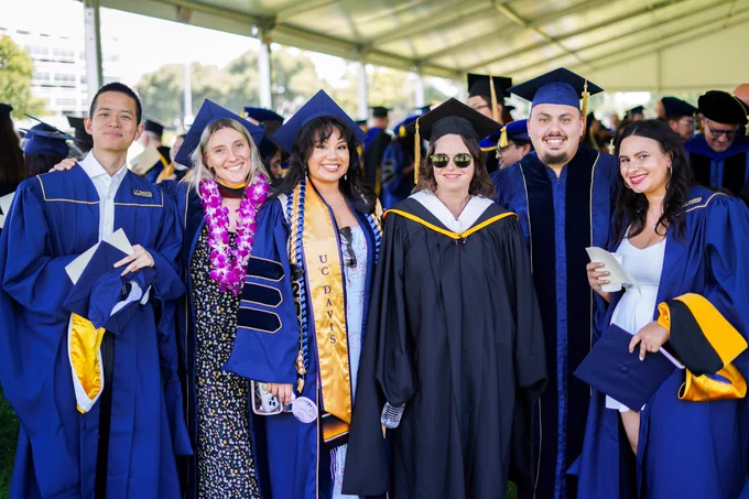 MFA and Doctoral students smiling with faculty.