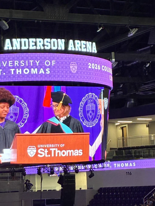 Dr. Shelley Neilsen Gatti handing out degrees to education graduates 