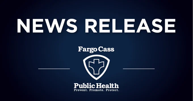 Bold white text reading 'NEWS RELEASE' on a dark blue background with Fargo Cass Public Health logo below.