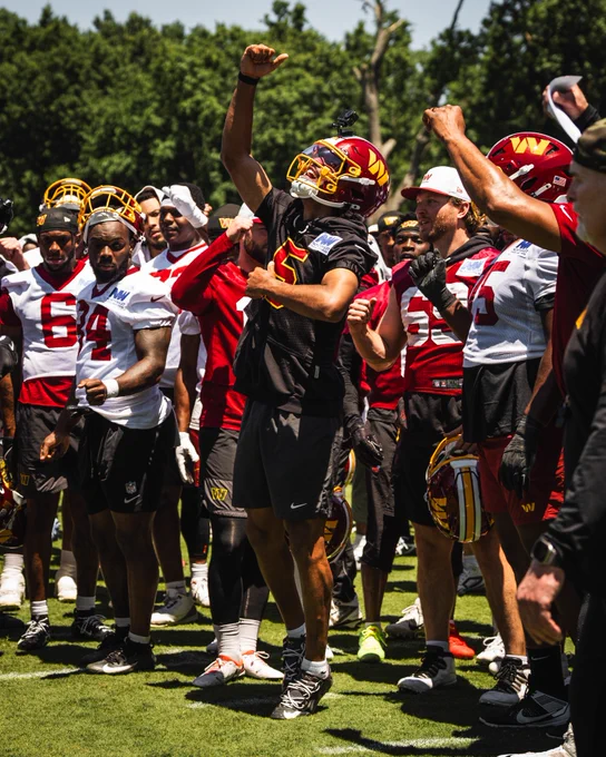 Photo of Jayden Daniels breaking down the huddle.