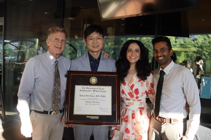 Dr. Joseph Kwon holding his degree with residency leadership.