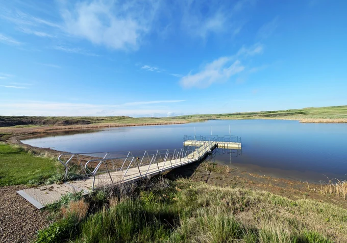 The fishing dock at the Blacktail Picnic Area offers a view of the lake and surrounding landscape. Forest Service photo by Scott C. Marvin.