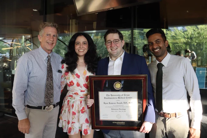 Dr. Ryan Assadi holding his degree with residency leadership.