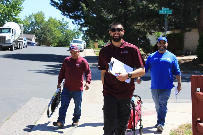 Volunteers walking to their next installation, smiling