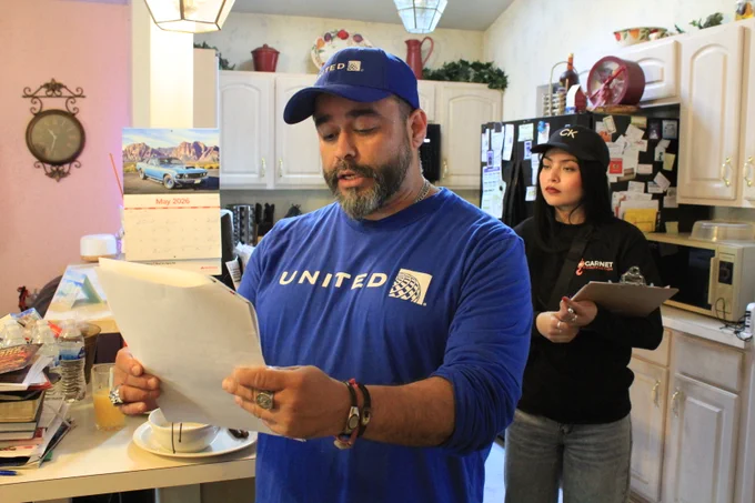 A volunteer from United Airlines gives information to a homeowner