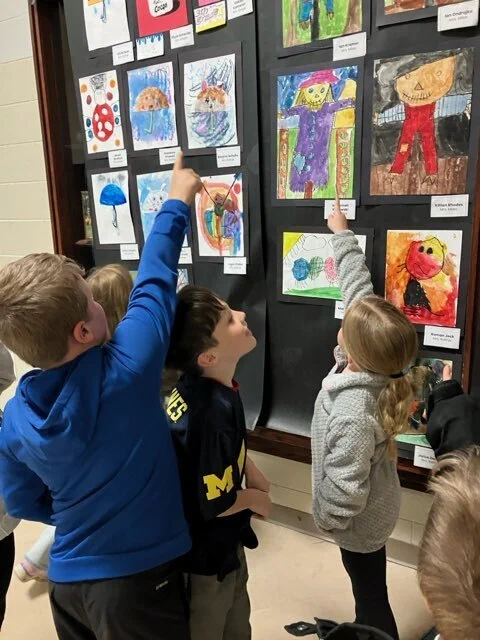 Students in Mrs. Miles' Class enjoy viewing art at the 2026 Fine Arts Night. 