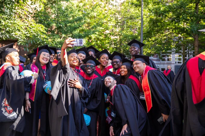 Graduates taking a selfie.