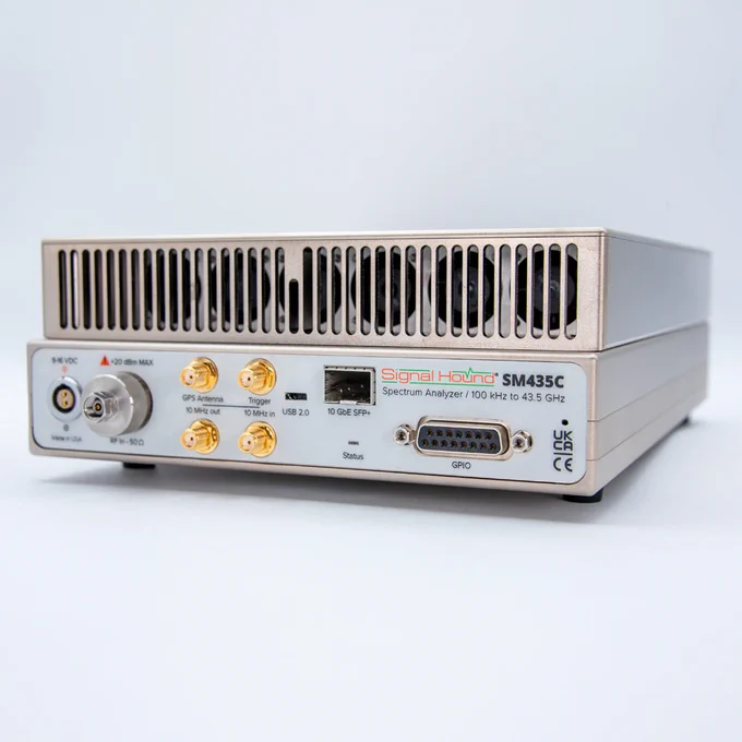 The image features a Signal Hound SM435C spectrum analyzer, featuring various ports and connectors, including USB and Ethernet. The device is marked with its name and frequency range from 100 kHz to 43.5 GHz.