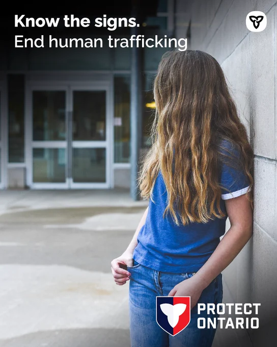 Young person leaning against a wall, looking away; campaign urging "Know the signs" to end human trafficking