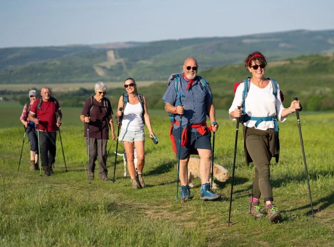 A group of people walking in a field.