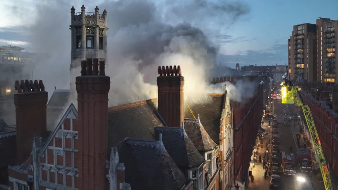 An image from a drone showing smoke arising from a building.