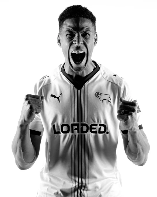 Curtis Davies roars into the camera with fist clenched in a celebration, while modelling the new Derby County 2026/27 PUMA home kit.