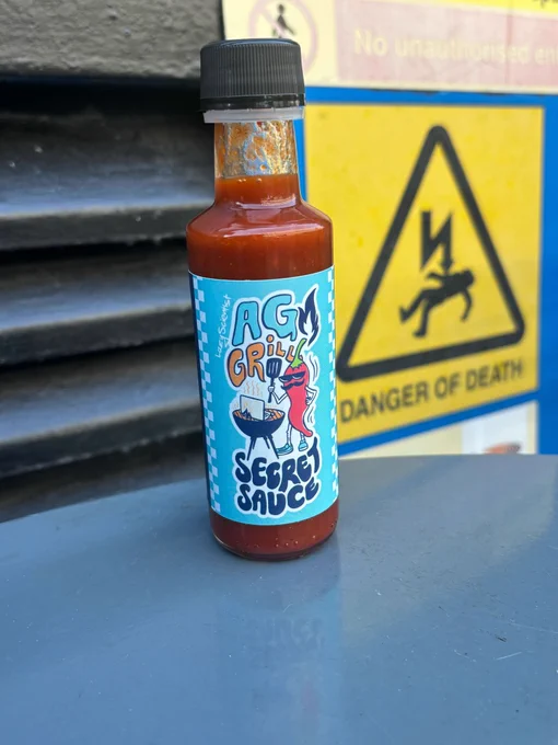 a bottle of hot sauce called "AG GRILL - Secret Sauce"