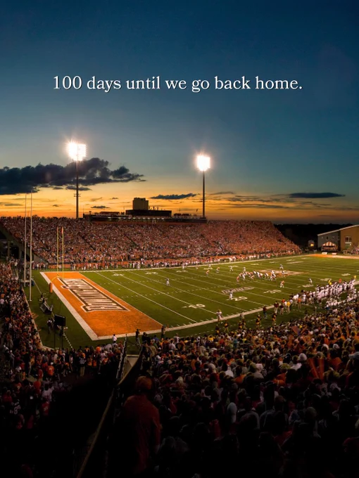 People at the Doyt during a football game with text saying “100 days until we go back home.”