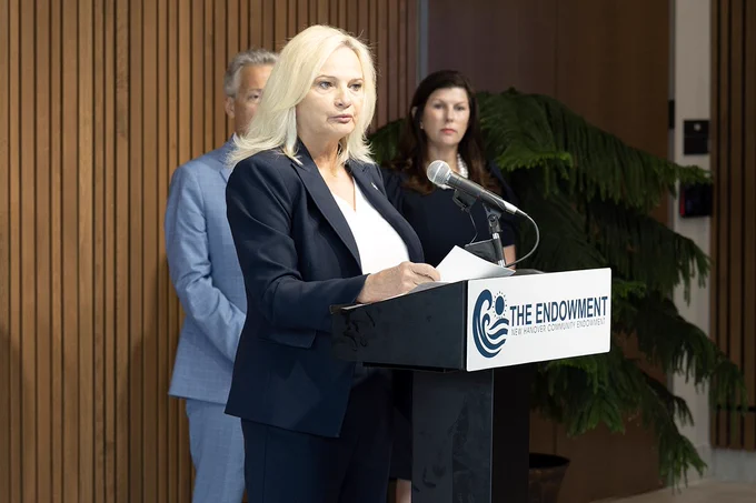 NHC Commissioner Chair standing behind podium that says "The Endowment"