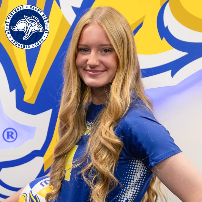 Close-up portrait of a person with long, light-colored hair wearing a blue South Dakota State volleyball jersey. In the upper left corner, a circular graphic with the Jackrabbit logo reads “Happy Birthday” around the edge.