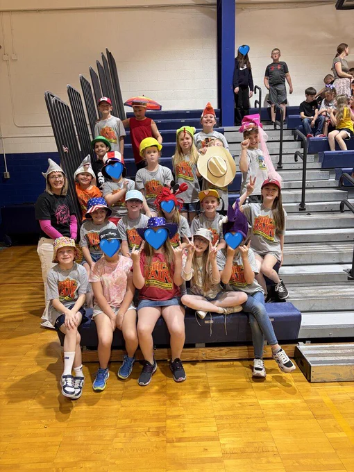 Students stand smiling at the Bad Axe Middle School SHARP Assembly. 