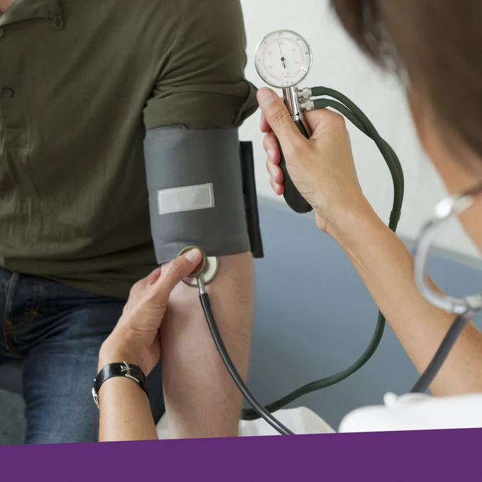 A doctor is measuring the blood pressure of a patient.