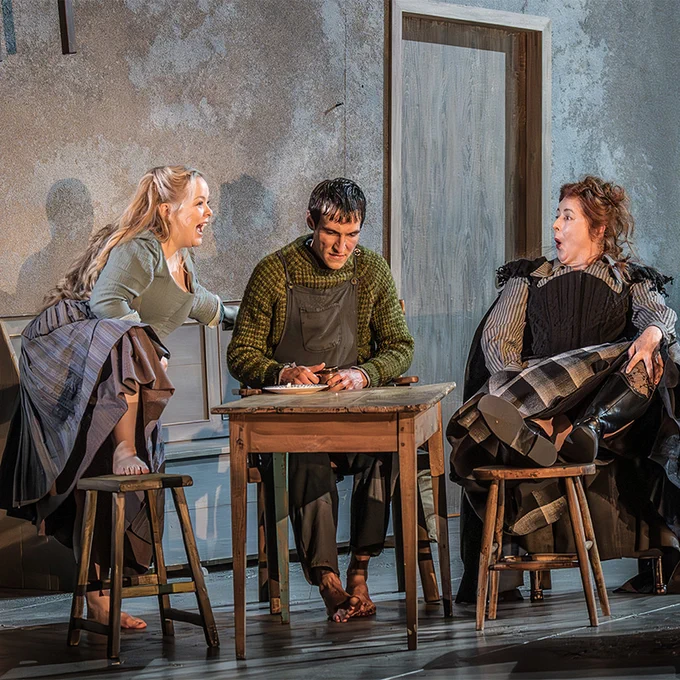 Nicola Coughlan, Eanna Hardwicke and Siobhan McSweeney sit around a table in a pub on stage.