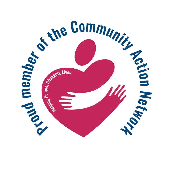 Logo: Community Action Agency "Huggy Heart" (a graphic of a heart that is partially shaped as a person hugging someone else) with the words "Helping People. Changing Lives." inside the heart, which is encircled by the words "Proud member of the Community Action Network."