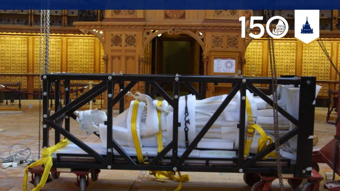 Statue of Queen Victoria secured inside a metal transport frame during preparations for the renovation of the Library of Parliament.