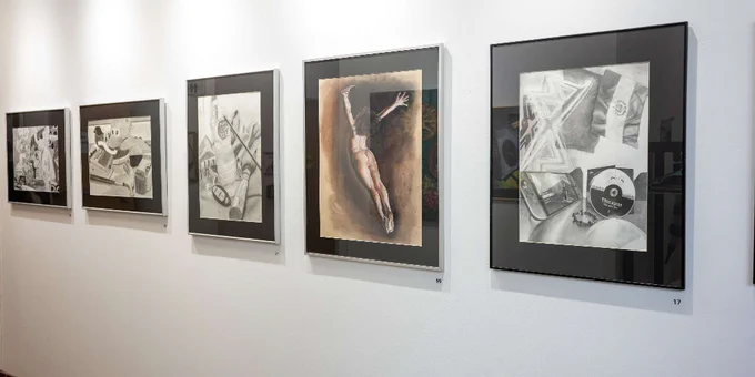 Gallery wall displaying five framed monochrome artworks, including various abstract compositions.
