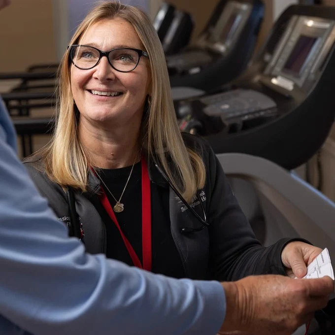 A person in a gym looking at a patient
