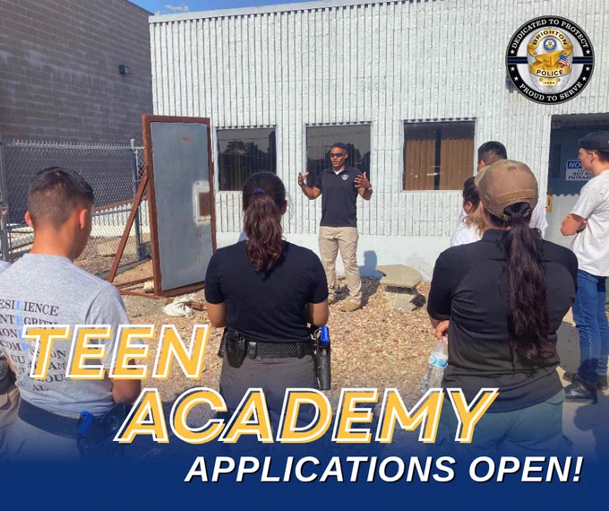 A police officer instructs a group of teens outside a training facility during a Teen Academy session.