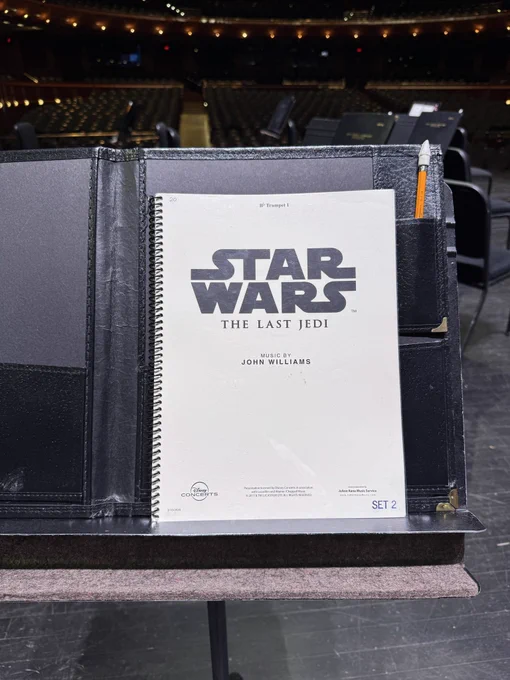 Star Wars: The Last Jedi sheet music cover on a music stand on stage.