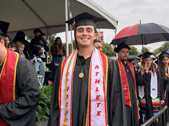 JAred Sawyer smiling on a gloomy day at commencement.