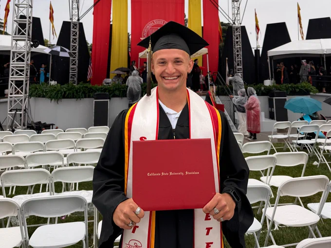 Julian Sanchez smiling ear to ear at commencement.