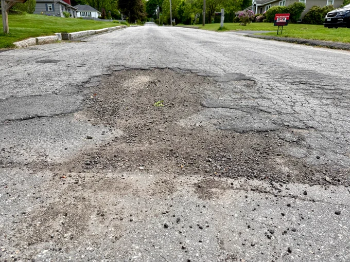 A street in Manchester, New Hampshire that is in desperate need of repair.