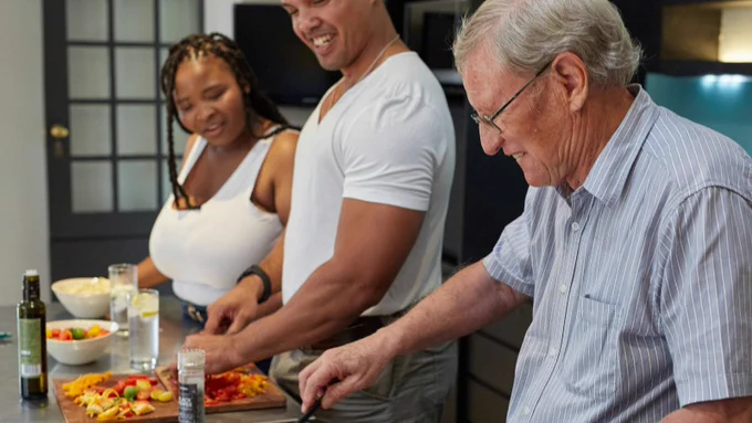 Three people cooking healthy food together
