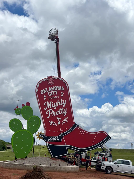 Massive red boot sculpture being installed