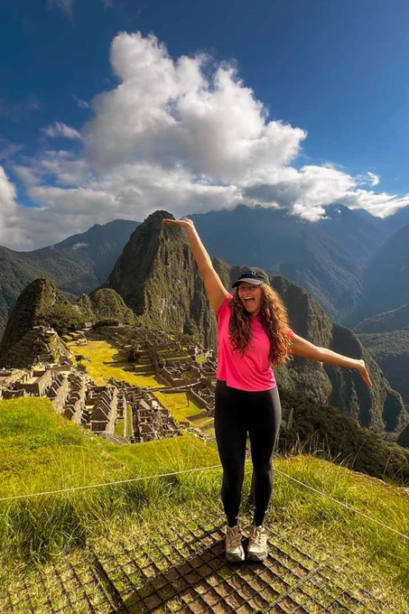 a photo of a person smiling in front of a mountain