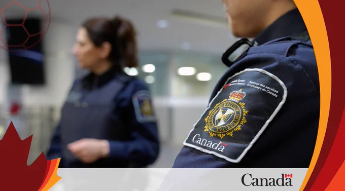 Close-up of a CBSA officer's uniform patch with a blurred colleague in the background.
