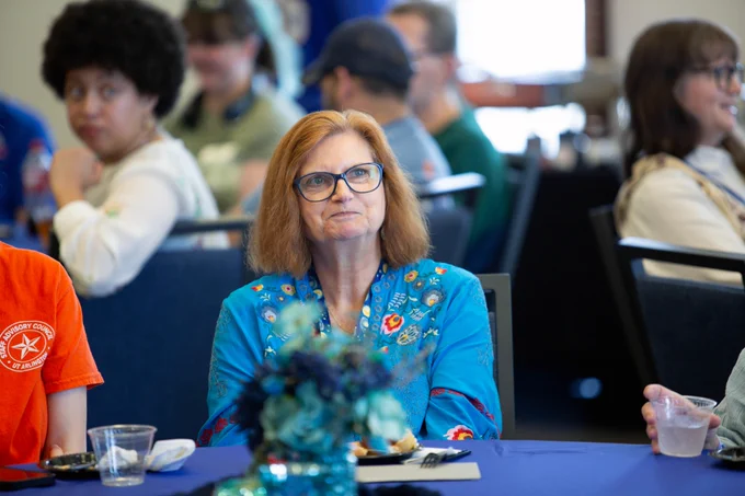 Pictured is a photo of UTA Libraries staff members Bonnie Dreitner, Budget Accounting Clerk, sitting at a table at her retirement party.