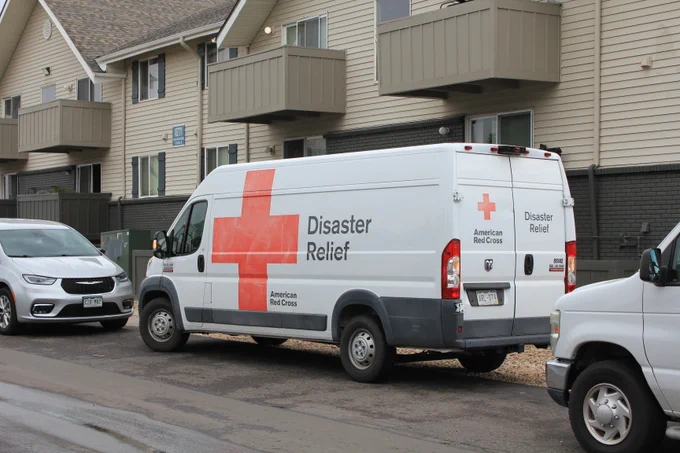 Red Cross Disaster Relief vehicle parked outside of an apartment