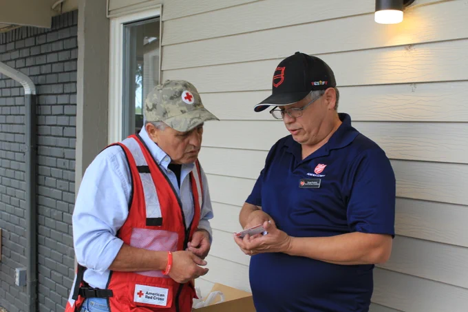 Red Cross and Salvation Army volunteers having a conversation