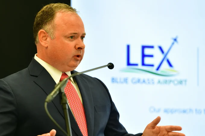 Airport Board Chair Brian Wells speaks at Future LEX announcement in front of the new Blue Grass Airport logo.