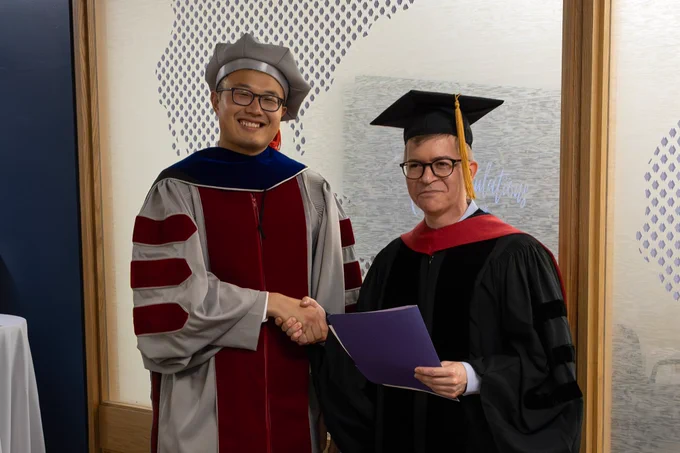 Raymond Wang, left, receives Best Doctoral Thesis Award from Political Science Department Head David Singer.