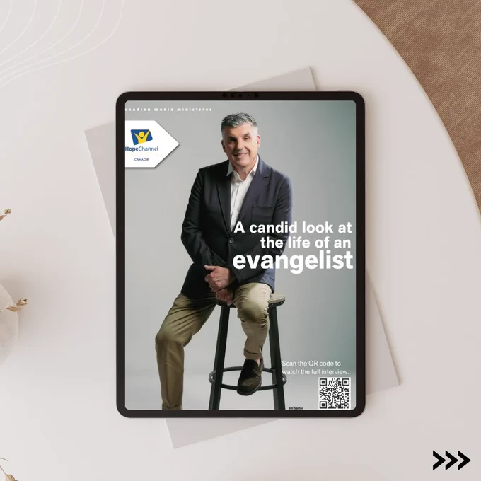 An image showcasing a man seated on a stool with a candid smile, promoting his interview available via a QR code.